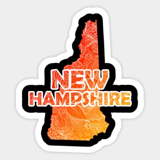 Colorful mandala art map of New Hampshire with text in red and orange Sticker